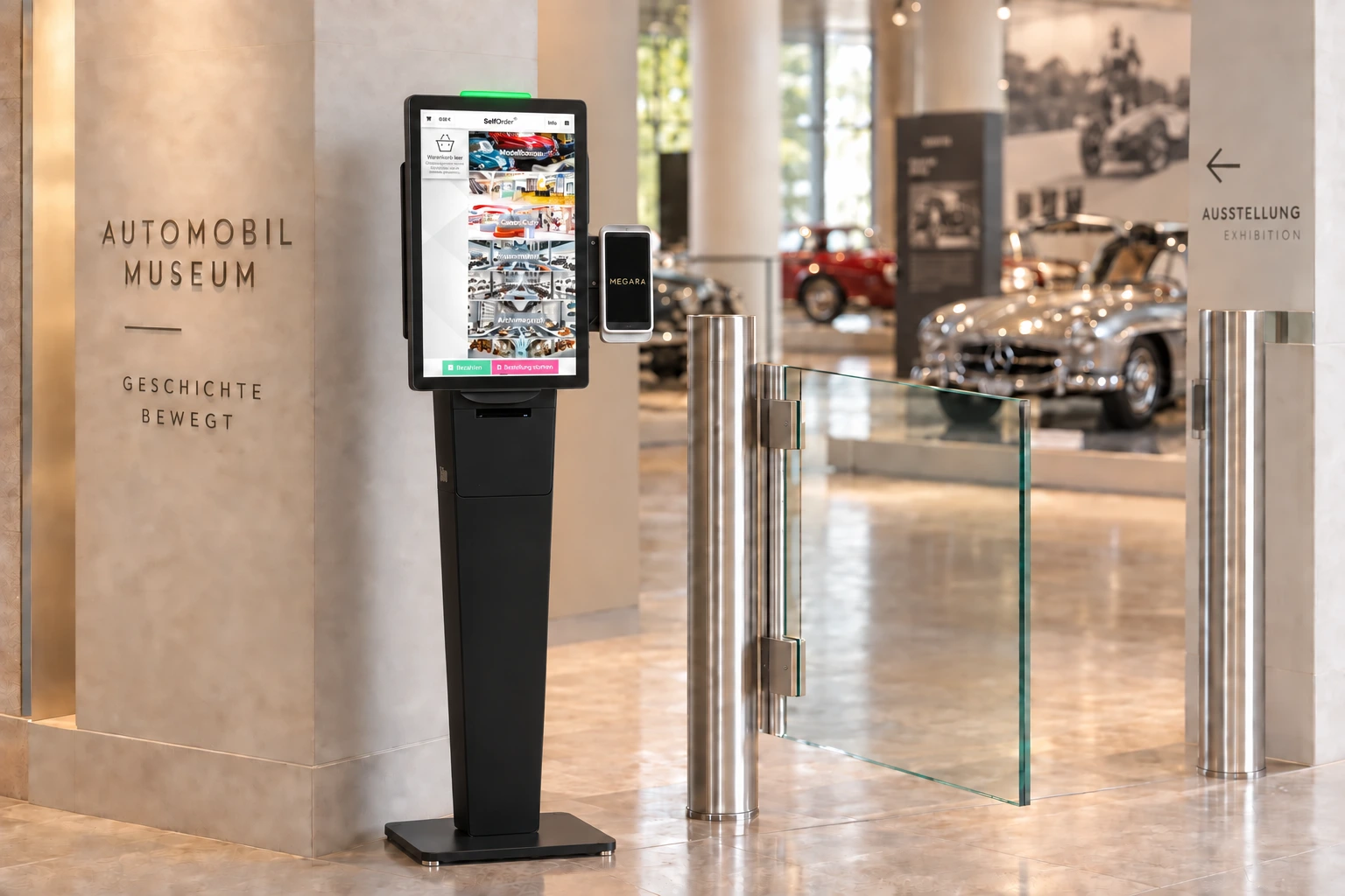 Black Elo SelfOrder terminal with a green status light and side-mounted card reader displaying the Megara logo beside a glass swing gate in a museum